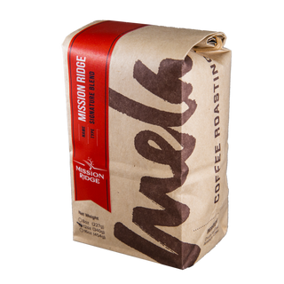 Bag of Mission Ridge Blend coffee featuring a red label and brown map like graphics