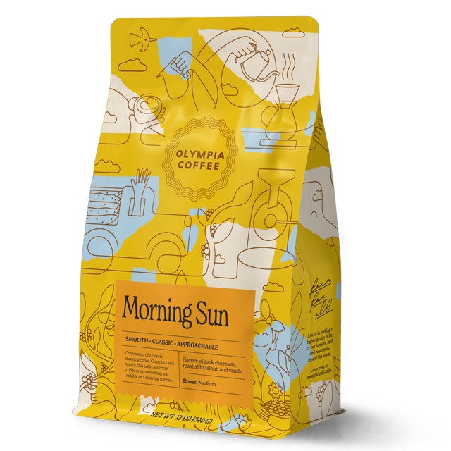 Morning Sun coffee bag with yellow and teal abstract pattern rests against a green background with a Morning Sun label.