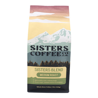 Front view of Sisters Blend coffee bag with mountain scene and medium roast label