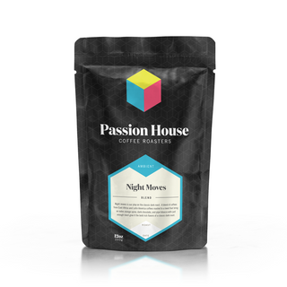 Night Moves blend bag from Passion House Coffee Roasters with a blue and pink cube logo on a black patterned bag.