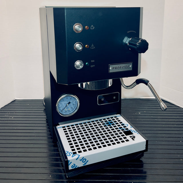 Open Box Profitec GO espresso machine front panel with two chrome knobs, an attached portafilter on the right, and PROFITEC badge.