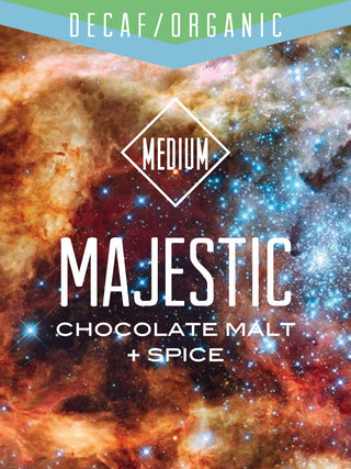 Majestic Decaf Organic coffee label with chocolate malt plus spice set against a cosmic nebula background