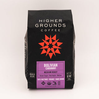 Black Higher Grounds Coffee bag with bold white logo and red star emblem; Bolivian Caranavi label visible.