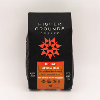 Close-up of a black Higher Grounds Coffee bag with white logo and a red geometric star design, decaf label at the bottom