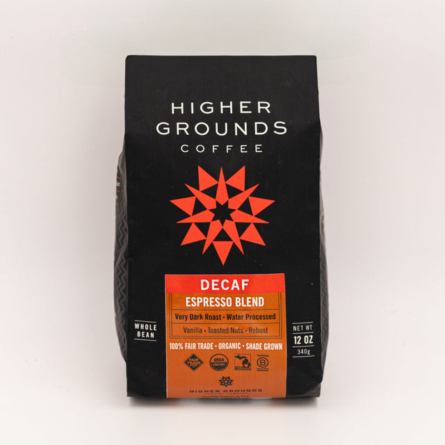 Close-up of a black Higher Grounds Coffee bag with white logo and a red geometric star design, decaf label at the bottom