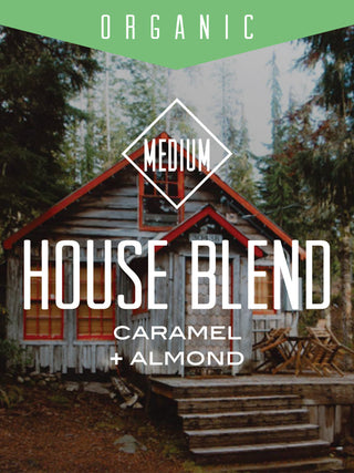 Organic House Blend coffee label over a forest cabin scene with a green organic banner at the top