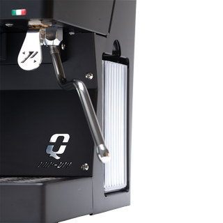 Close up of Quick Mill Pop Up espresso machine showing the portafilter and metal lever on a dark body