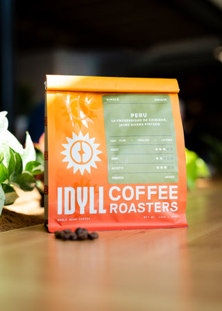 Peru La Prosperidad de Chirinos Cajamarca single origin coffee bag with blue label on bright orange packaging.