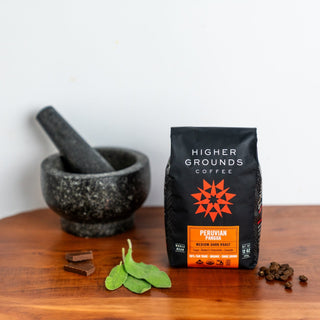 Full view of a black Higher Grounds coffee bag labeled Peruvian Pangoa with an orange roast label indicating medium dark roast.