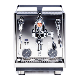 Front view of a chrome Profitec Drive espresso machine with E61 group head, red pressure gauge, and dual side levers.