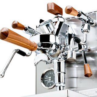 Close up of a Profitec JUMP espresso machine showing wooden lever handles and polished chrome fittings