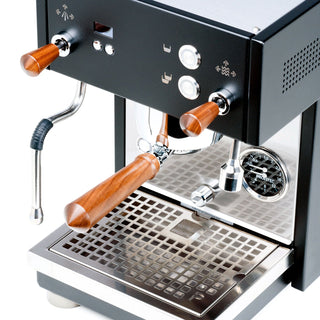 Angled front view of Profitec MOVE espresso machine with copper control knobs portafilters and stainless steel drip tray