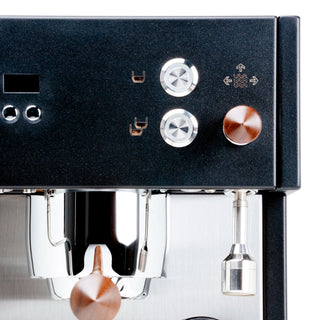 Close-up of Profitec MOVE espresso machine front panel with two chrome dials and a copper knob.