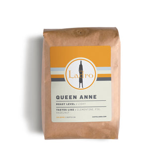 Queen Anne coffee bag with orange label and striped band featuring the Ladro circle logo