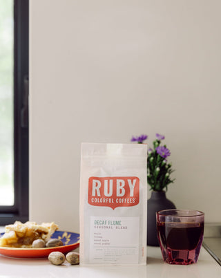 White Decaf Flume Seasonal Blend bag on a countertop with the red RUBY logo visible.