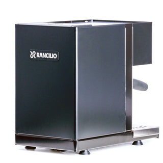 Open box ECM Classika 9887 espresso machine in a dark stainless finish with top handles visible.