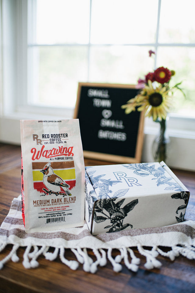 Waxwing All-Purpose Blend coffee bag with Red Rooster branding on a counter.