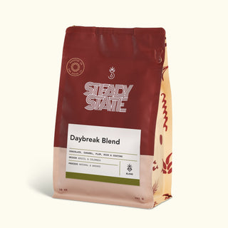 Daybreak Blend coffee bag with bold typography and a green bottom band