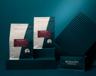 Sumatra Mandheling coffee bags with Arte della Tazza packaging visible in the teal display