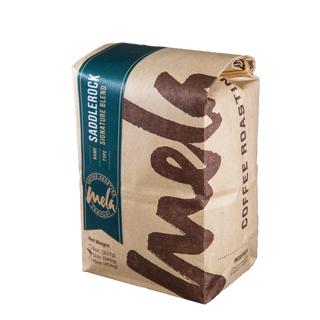 Saddlerock Blend coffee bag with a red label and teal Mela Coffee Roasting Co branding.