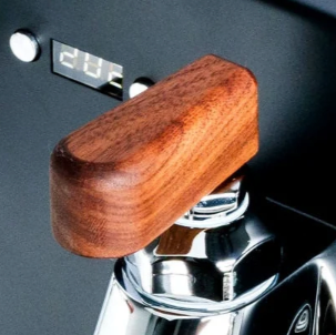 Walnut flow control paddle mounted on an E61 group head espresso machine