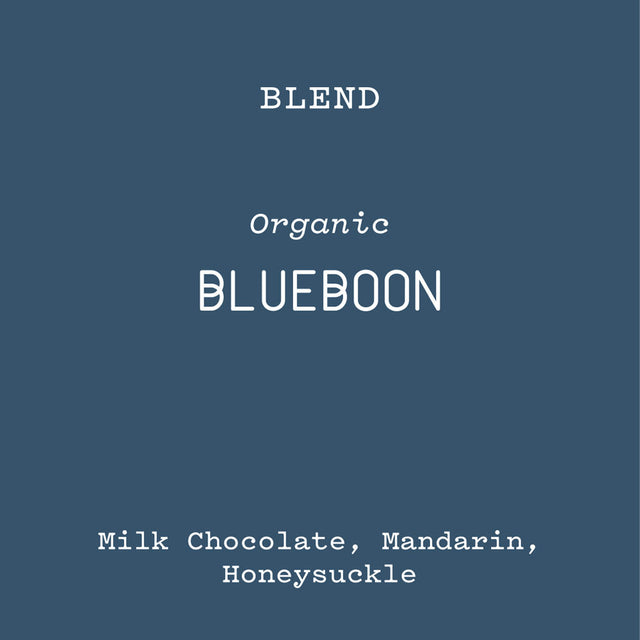 Blueboon organic blend label on a blue background with notes Milk Chocolate Mandarin Honeysuckle.