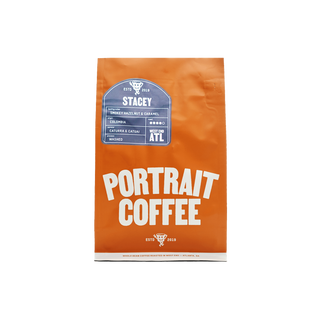 Orange STACEY coffee bag standing upright with a blue label and bold Portrait Coffee typography
