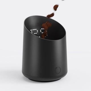 Subminimal Subscale with coffee beans pouring into open top of the black cylinder, LED readout inside.