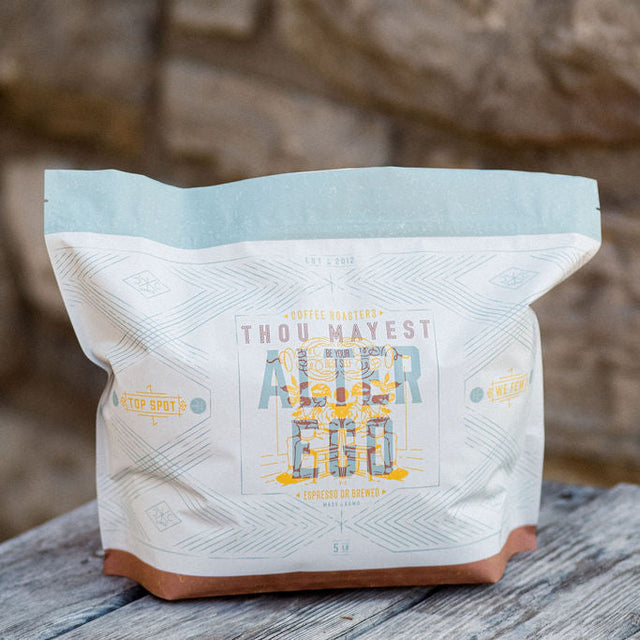 Alter Ego coffee bag with a white body a pale blue top and a brown base on a wooden surface