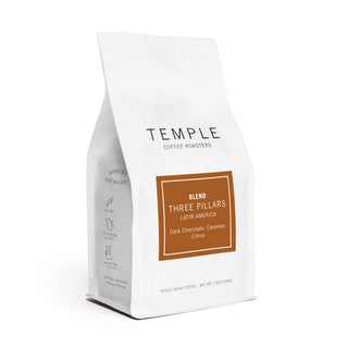 Angled white coffee bag displaying Temple Coffee Roasters Three Pillars blend label