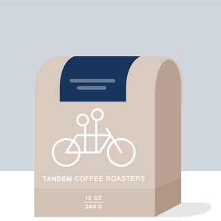 Uriel Cardona Colombia coffee bag with bicycle graphic on a beige bag