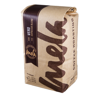 Vero Espresso coffee bag with dark label and kraft paper wrap from Mela Coffee Roasting Co.