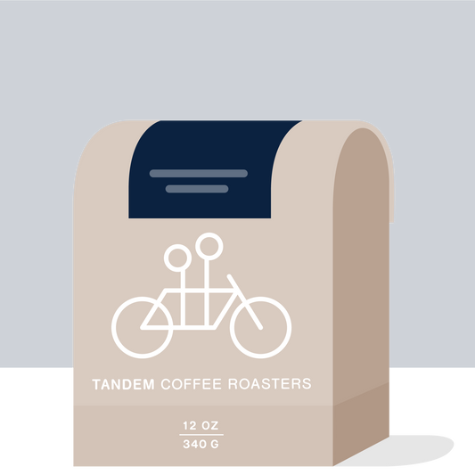 West End Blues coffee packaging with navy backdrop beige curves and Tandem Coffee Roasters branding