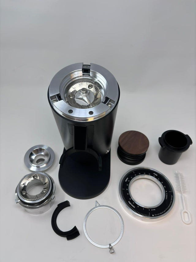 Turin DF64 Gen 2.5 single dose grinder with burr assembly and accessories laid out on a white surface.