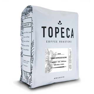 Angled Topeca coffee bag featuring bold TOPECA logo and Zingo Espresso Blend label with plant illustrations