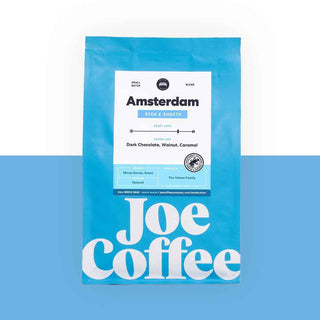 Blue Amsterdam coffee bag with a white label and large Joe Coffee logo