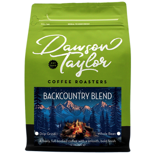 Backcountry Blend coffee bag with a mountains and campfire label on bright green packaging.