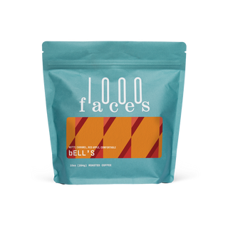 Teal bag of Bell's rotating blend coffee from 1000 Faces Coffee with an orange patterned label