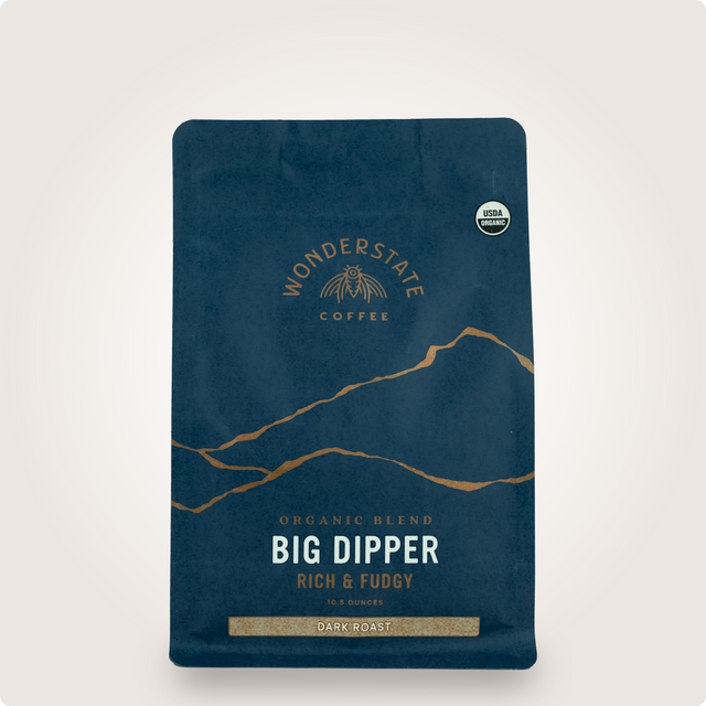 Dark blue Big Dipper coffee bag with gold emblem and USDA Organic badge, a dark roast label.