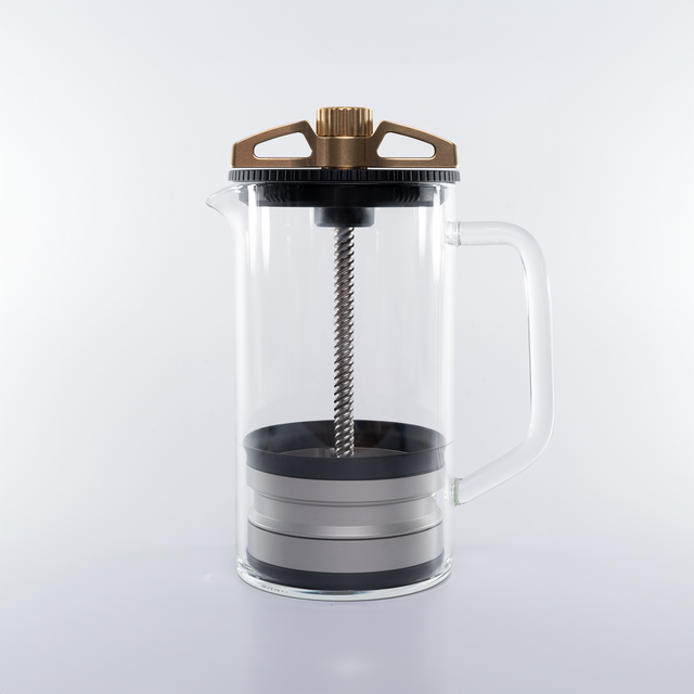 Side view of The BIRD coffee brewer with bronze crown glass carafe and handle