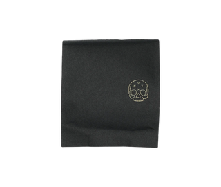 Black coffee bag featuring a gold skull logo and subtle brand mark
