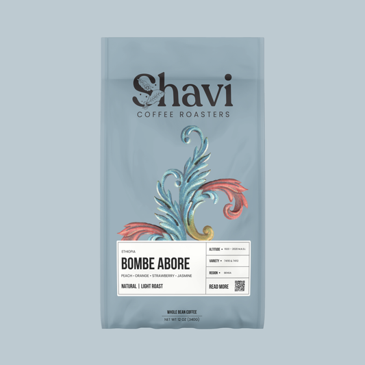Blue coffee bag featuring the Shavi Coffee Roasters logo and a botanical illustration