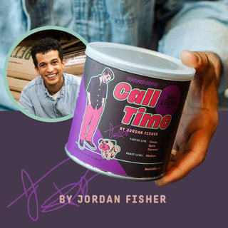 Smiling man in a denim shirt holds a Call Time coffee can with a bold label.
