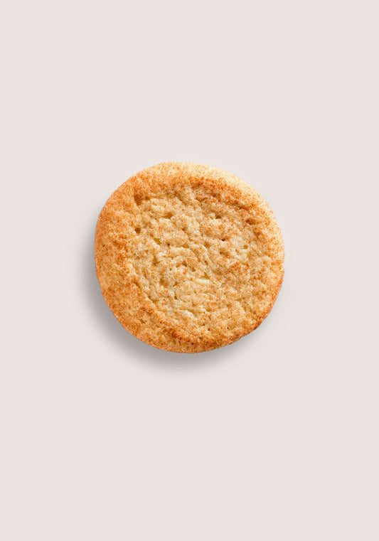Round golden brown cookie centered on a pale beige background