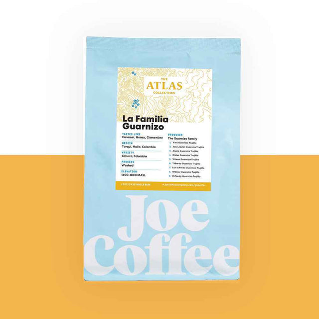 Blue coffee bag labeled La Familia Guarnizo Atlas Collection on an orange background
