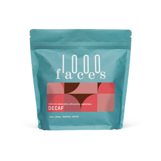 Teal 1000 Faces Decaf coffee bag with a red geometric label reading DECAF.