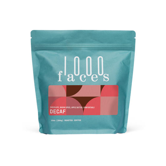 Teal 1000 Faces Decaf coffee bag with a red geometric label reading DECAF.