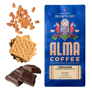 Alma Coffee Dreamer decaf bag in blue with almonds crackers and chocolate beside