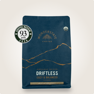 Driftless Wonderstate Coffee bag in dark blue with mountain illustration and Organic and Coffee Review badges