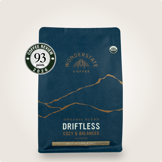 Driftless Wonderstate Coffee bag in dark blue with mountain illustration and Organic and Coffee Review badges